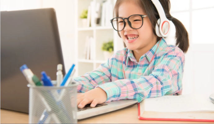 Little girl on laptop doing homework