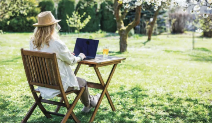 Woman outside on her laptop